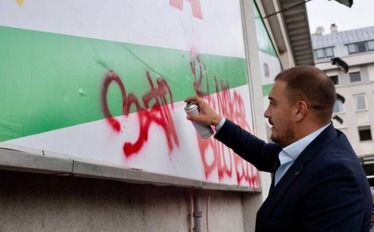 Faruk Kapidžić i Haris Zahiragić dopisuju poruku na SDA plakat na Šipu