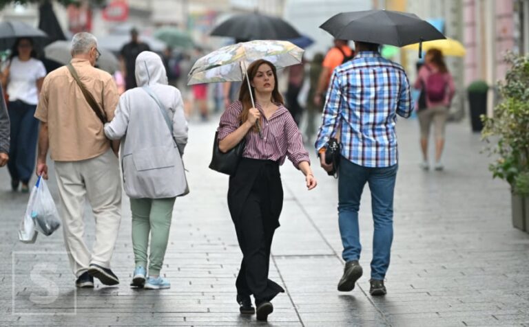 Kišna ulica u Sarajevu s građanima pod kišobranima